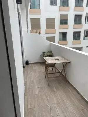 a balcony with a table and a building at Stay luxe in Casablanca