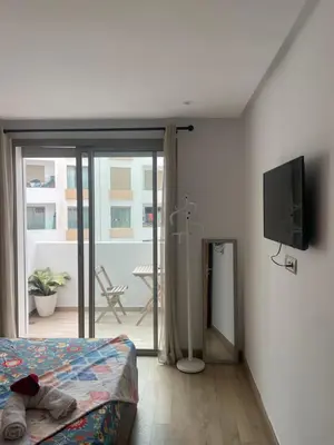 a bedroom with a bed and a flat screen tv at Stay luxe in Casablanca