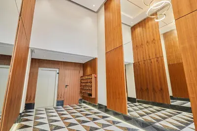 a room with wood panels and a checkered floor at AFCON Casablanca 5 min Walk to Stadium Private Terrace 65 inch TV Fiber Internet All Sports Channels in Casablanca