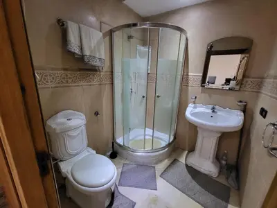 a bathroom with a toilet and a shower and a sink at wbdixmude in Casablanca