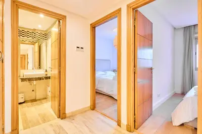 a bathroom with a door leading to a bedroom at Oceanfront 2BR by Hassan II Mosque in Casablanca