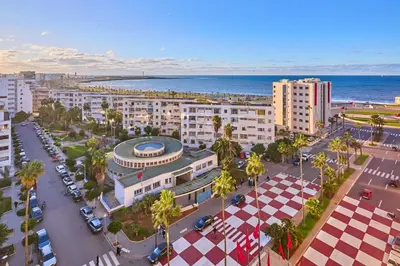 an aerial view of a city with buildings and the ocean at Oceanfront 2BR by Hassan II Mosque in Casablanca