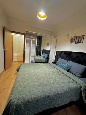 a bedroom with a large bed in a room at Cozy appartement Rabat Wifak 5min de Harhoura beach in Temara