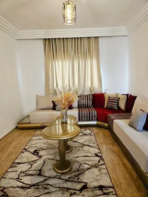 a living room with a couch and a table at Sunset Ocean View in Rabat