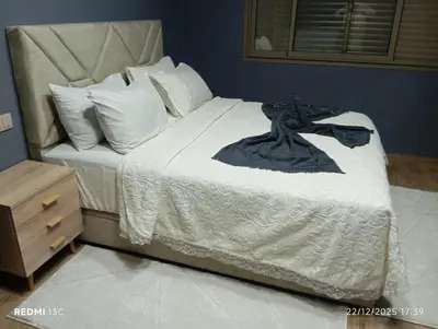 a bed with a black dress on it at Loge studio agdal in Rabat