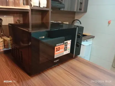 a microwave oven sitting on top of a wooden floor at Loge studio agdal in Rabat