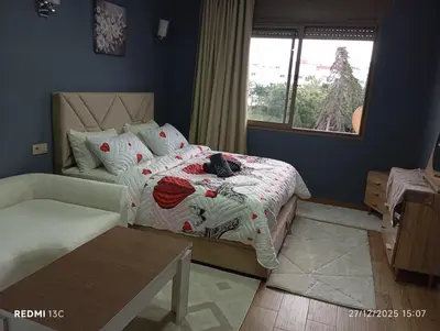 a bedroom with a bed and a window at Loge studio agdal in Rabat