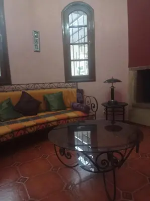 a living room with a couch and a table at 2 bedroom apartment and living room with small terrace in Skhirat