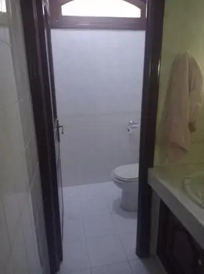 a bathroom with a toilet and a shower and a sink at 2 bedroom apartment and living room with small terrace in Skhirat