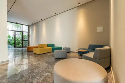 a waiting room with colorful chairs and a table at Self Check In 1BR With Gym And Coworking Near CFC in Casablanca