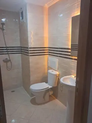 a bathroom with a toilet and a sink at Baya Residentie in Temara