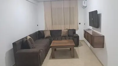 a living room with a couch and a coffee table at Baya Residentie in Temara