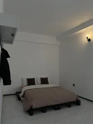a bedroom with a bed in a white wall at Cozy getaway for a perfect stay in Rabat
