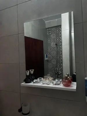 a mirror on a wall in a bathroom at Cozy getaway for a perfect stay in Rabat