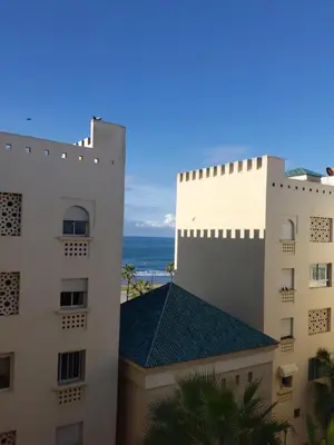 a view of two buildings and the ocean at Beautiful Apartment for Rent in Corniche de Rabat in Rabat