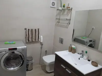 a bathroom with a washing machine and a sink at Sea view Apart Rabat in Rabat