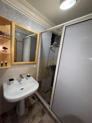 a bathroom with a sink and a shower at Appartement idéal pour la CAN à 5 min du stade Moulay Abdellah in Rabat
