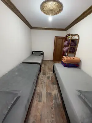 a room with two beds and a ceiling at Appartement idéal pour la CAN à 5 min du stade Moulay Abdellah in Rabat