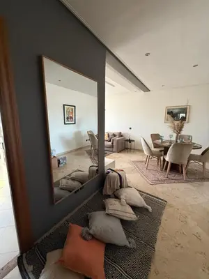 a living room with a large mirror on the wall at Appartement cosy 2 chambres à Agdal, à 5 min de la Gare in Rabat