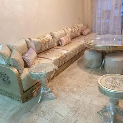 a living room with a couch and a table at Appt Mansbay beach in Mansouria