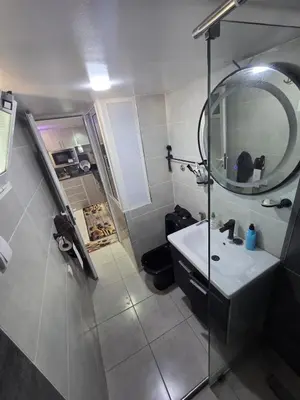 a bathroom with a sink and a mirror at Appartement meublée à RABAT for CAN 2025 in Temara