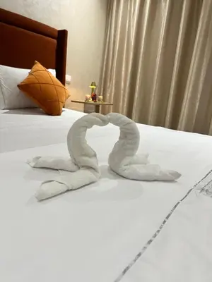 a towel shaped like a heart laying on a bed at Studio Glamour centre ville & Casa port in Casablanca