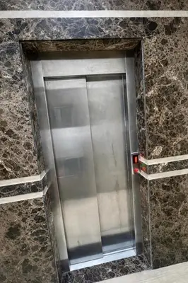 a metal elevator in a stone wall at Studio Glamour centre ville & Casa port in Casablanca