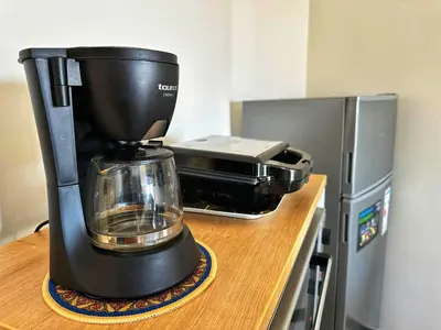 a coffee maker sitting on a counter next to a microwave at Studio Premium à Agdal , Confort et emplacement in Rabat