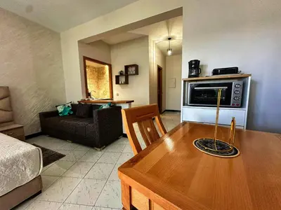a living room with a table and a microwave at Studio Premium à Agdal , Confort et emplacement in Rabat