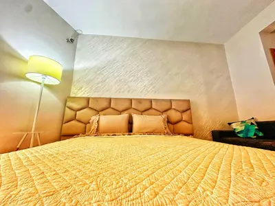 a bedroom with a large bed and a lamp at Studio Premium à Agdal , Confort et emplacement in Rabat