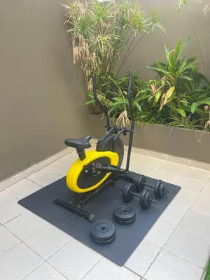 a exercise bike on a mat on a floor at Spacious Modern Apartment with Large Sunny Terrace in Central Casablanca in Casablanca