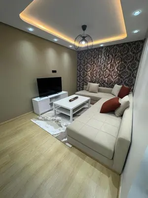 a living room with a couch and a tv at Modern Cozy Studio with Open-Plan Kitchen near All Amenities Rabat in Rabat