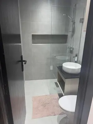 a bathroom with a toilet and a sink and a shower at Modern Cozy Studio with Open-Plan Kitchen near All Amenities Rabat in Rabat