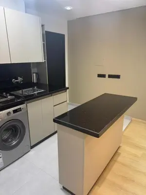 a kitchen with a counter top and a washing machine at Modern Cozy Studio with Open-Plan Kitchen near All Amenities Rabat in Rabat