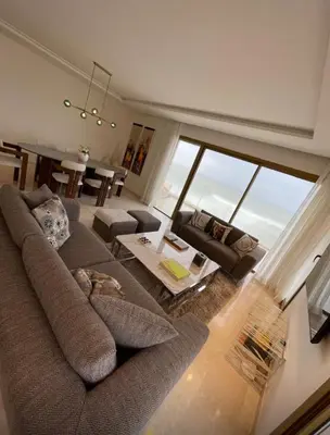 a living room with a large couch and a table at Carrousel Atlantic View in Rabat