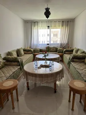 a living room with couches and a table and chairs at Premium comfort, 150m from Val d'Or beach, 2 swimming pools in Temara