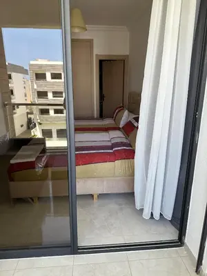 a view of a room with a bed and a window at Premium comfort, 150m from Val d'Or beach, 2 swimming pools in Temara