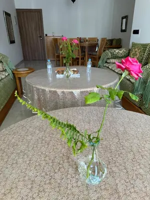 a vase with a pink rose on a table at Premium comfort, 150m from Val d'Or beach, 2 swimming pools in Temara