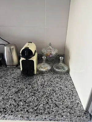 a toaster and two wine glasses on a counter at Premium comfort, 150m from Val d'Or beach, 2 swimming pools in Temara