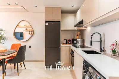 a kitchen and dining room with a table and chairs at Sakura - 100 Mbps Wi-Fi - Downtown Casablanca in Casablanca