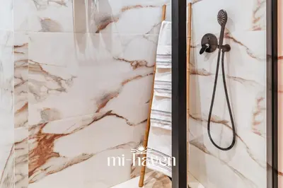 a shower in a bathroom with a marble wall at Sakura - 100 Mbps Wi-Fi - Downtown Casablanca in Casablanca