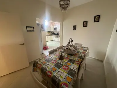 a room with a table with a blanket on it at Appartement 500 m from Moulay Abdellah Stadium in Temara