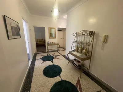 a living room with a hallway with a rug at Appartement 500 m from Moulay Abdellah Stadium in Temara