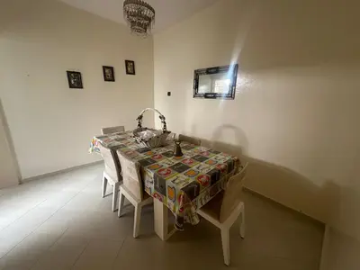 a table with a table cloth on it in a room at Appartement 500 m from Moulay Abdellah Stadium in Temara