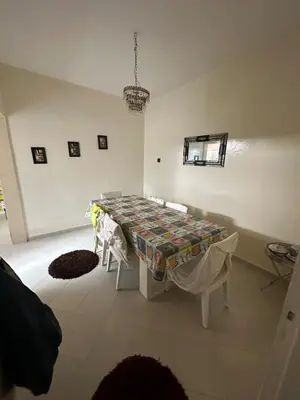 a white room with a table with a blanket on it at Appartement 500 m from Moulay Abdellah Stadium in Temara