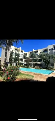 a large apartment building with a swimming pool at Appartement en bord de Mer in Mohammedia