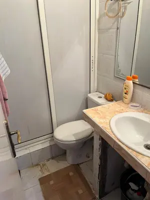 a bathroom with a toilet and a sink at Location des appartements souf in Temara