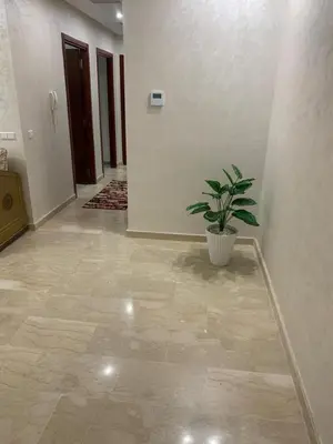 a hallway with a potted plant in a room at Apartment in a residence with pool in Mohammedia