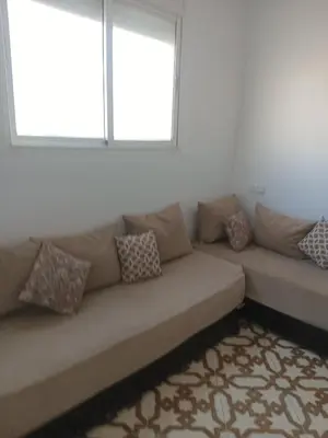 a couch in a living room with a window at Appartement temara in Temara