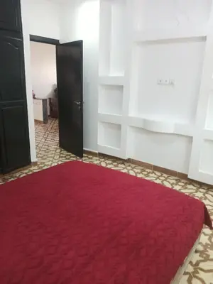a room with a red rug on the floor at Appartement temara in Temara